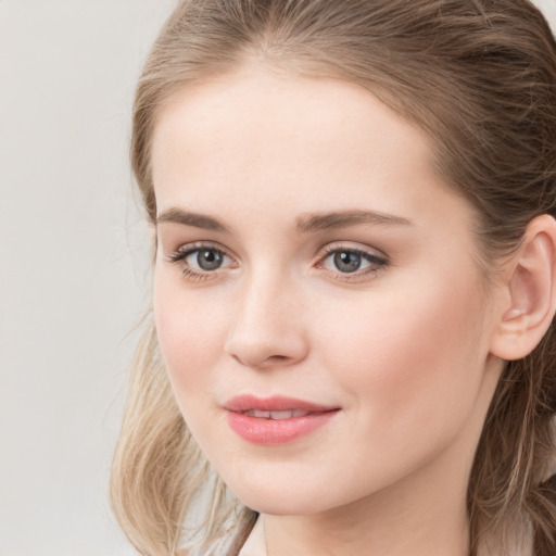 Joyful white young-adult female with long  brown hair and grey eyes