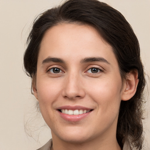 Joyful white young-adult female with medium  brown hair and brown eyes