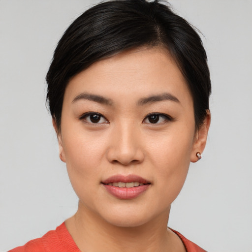 Joyful asian young-adult female with short  black hair and brown eyes