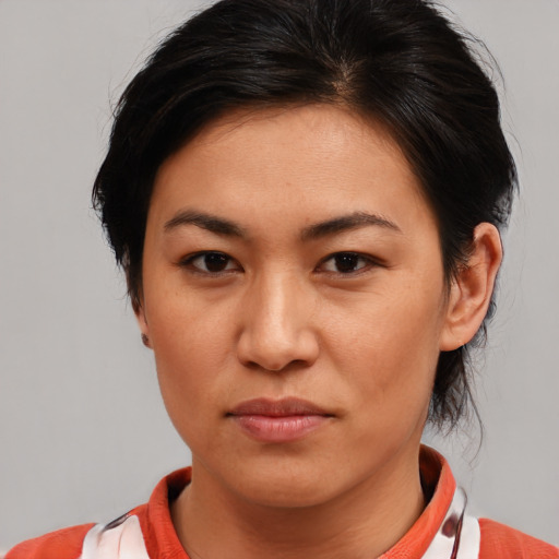 Joyful asian young-adult female with medium  brown hair and brown eyes