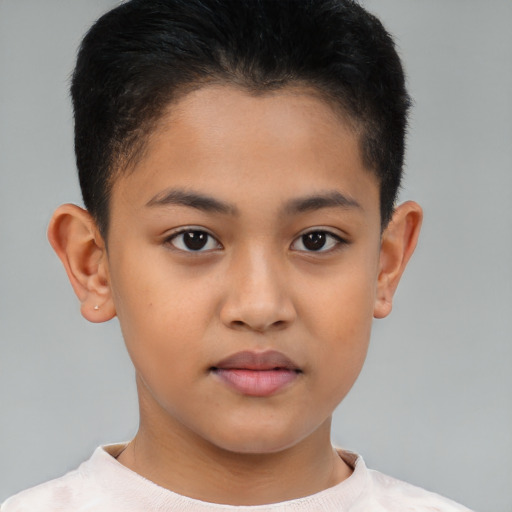 Joyful latino child male with short  brown hair and brown eyes