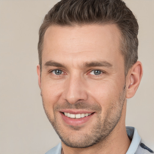 Joyful white young-adult male with short  brown hair and brown eyes