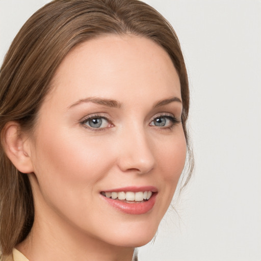 Joyful white young-adult female with medium  brown hair and grey eyes