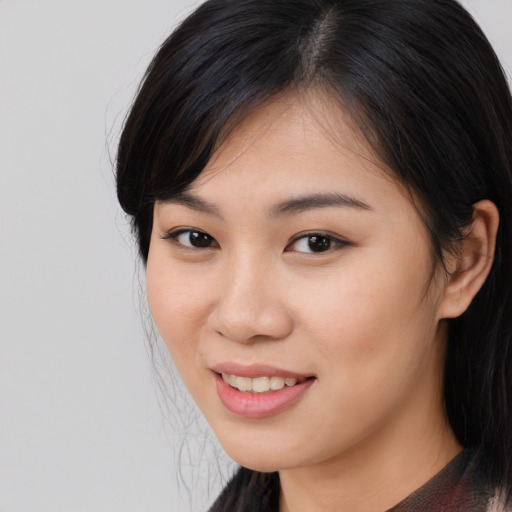 Joyful asian young-adult female with medium  black hair and brown eyes