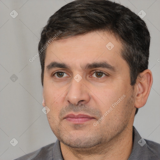 Joyful white young-adult male with short  black hair and brown eyes