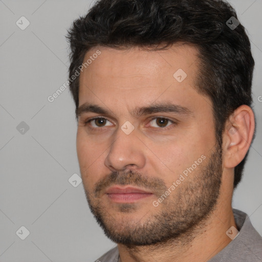 Joyful white adult male with short  black hair and brown eyes