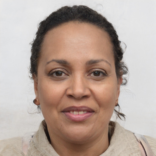 Joyful latino adult female with short  brown hair and brown eyes