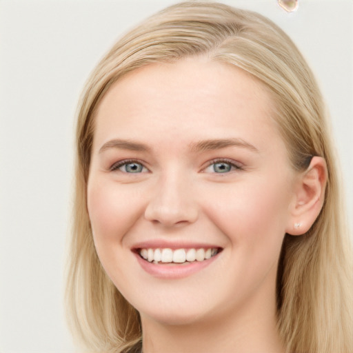 Joyful white young-adult female with long  brown hair and blue eyes