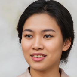 Joyful asian young-adult female with medium  brown hair and brown eyes