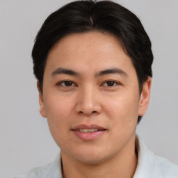 Joyful asian young-adult male with short  brown hair and brown eyes