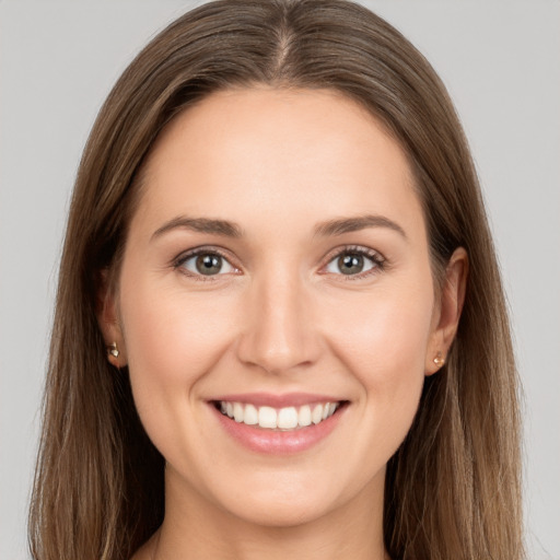 Joyful white young-adult female with long  brown hair and grey eyes