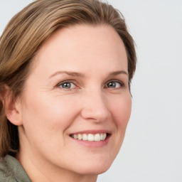 Joyful white young-adult female with medium  brown hair and green eyes