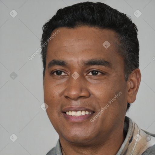 Joyful latino adult male with short  black hair and brown eyes