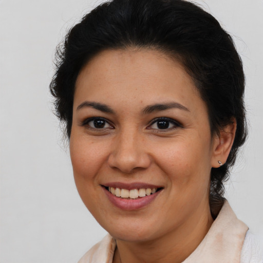 Joyful latino young-adult female with medium  brown hair and brown eyes