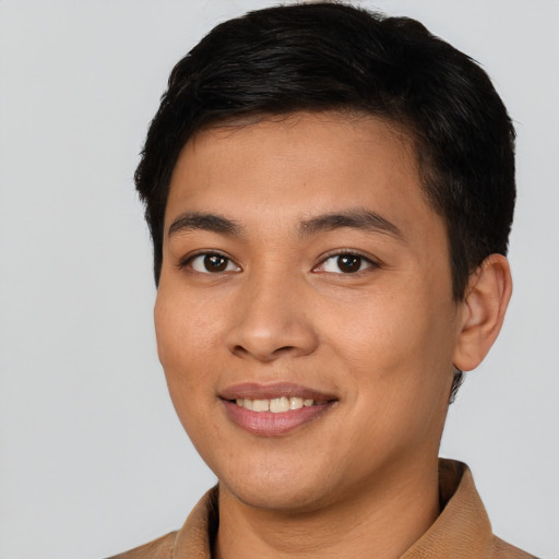 Joyful latino young-adult male with short  black hair and brown eyes