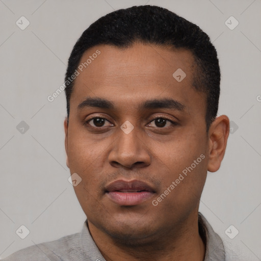 Joyful black young-adult male with short  black hair and brown eyes