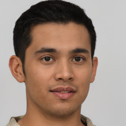 Joyful latino young-adult male with short  brown hair and brown eyes