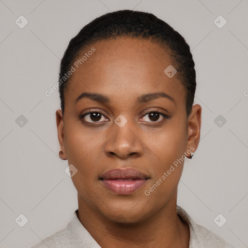 Joyful black young-adult female with short  black hair and brown eyes