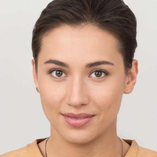 Joyful white young-adult female with short  brown hair and brown eyes