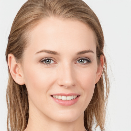 Joyful white young-adult female with long  brown hair and blue eyes