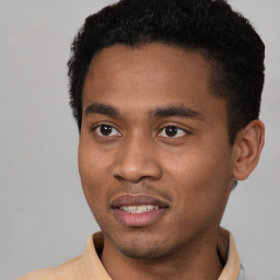 Joyful latino young-adult male with short  black hair and brown eyes