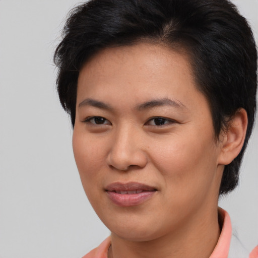 Joyful asian young-adult female with short  brown hair and brown eyes