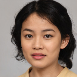 Joyful asian young-adult female with medium  black hair and brown eyes