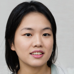 Joyful asian young-adult female with medium  black hair and brown eyes