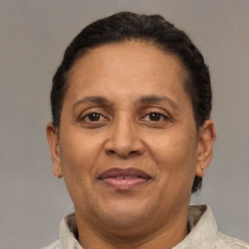 Joyful black adult female with short  brown hair and brown eyes