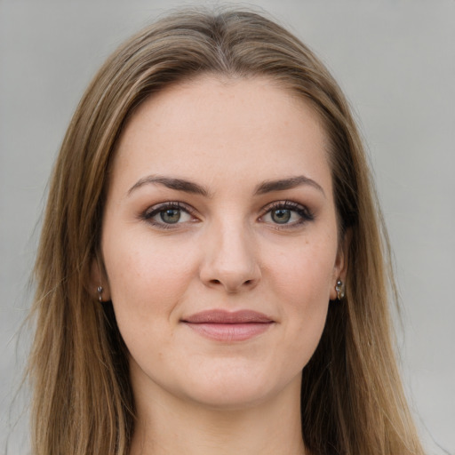 Joyful white young-adult female with long  brown hair and green eyes