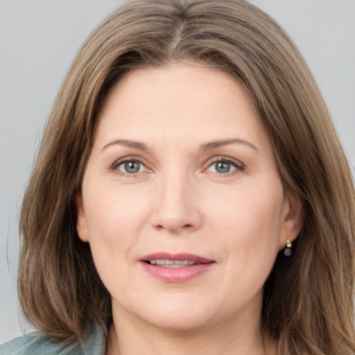 Joyful white adult female with medium  brown hair and grey eyes