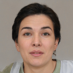 Joyful white adult female with short  brown hair and brown eyes