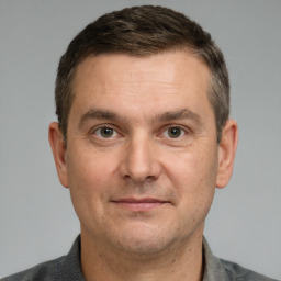 Joyful white adult male with short  brown hair and brown eyes