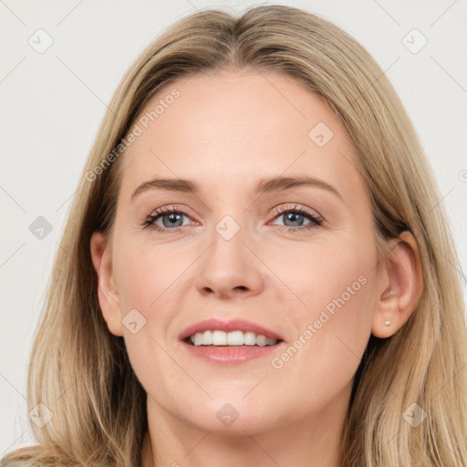 Joyful white young-adult female with long  brown hair and grey eyes