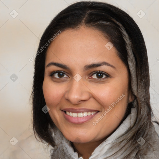 Joyful latino young-adult female with medium  brown hair and brown eyes