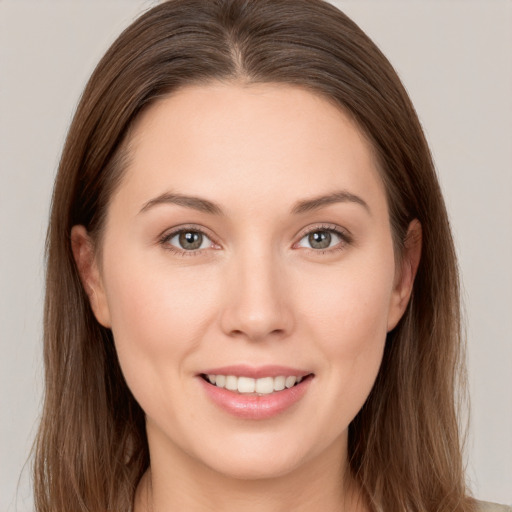 Joyful white young-adult female with long  brown hair and grey eyes