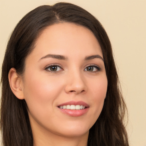 Joyful white young-adult female with long  brown hair and brown eyes