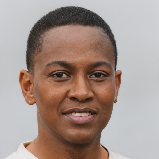 Joyful black young-adult male with short  brown hair and brown eyes