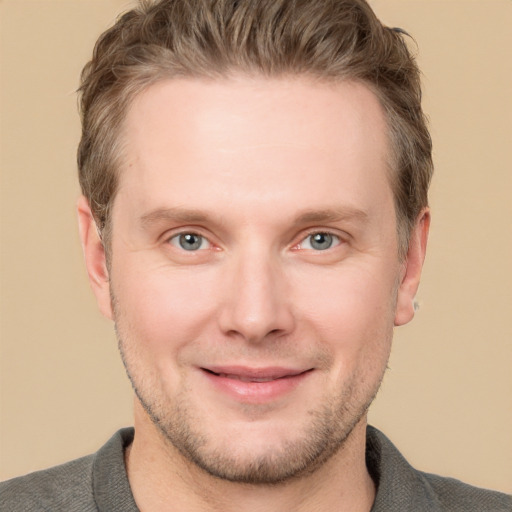 Joyful white adult male with short  brown hair and grey eyes