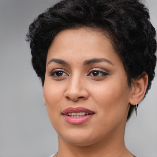 Joyful latino young-adult female with short  brown hair and brown eyes