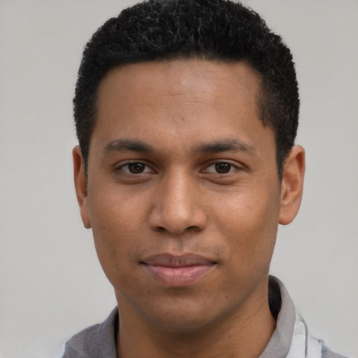 Joyful black young-adult male with short  black hair and brown eyes