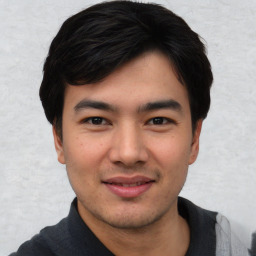 Joyful asian young-adult male with short  black hair and brown eyes