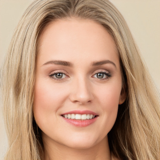 Joyful white young-adult female with long  brown hair and green eyes