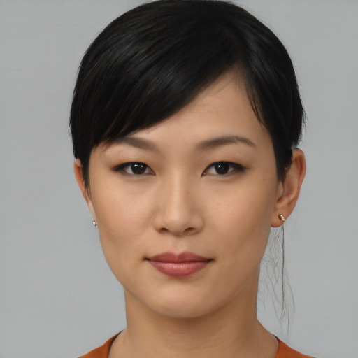 Joyful asian young-adult female with short  black hair and brown eyes