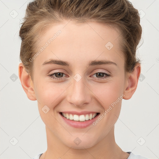 Joyful white young-adult female with short  brown hair and grey eyes