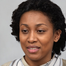 Joyful black young-adult female with short  black hair and brown eyes