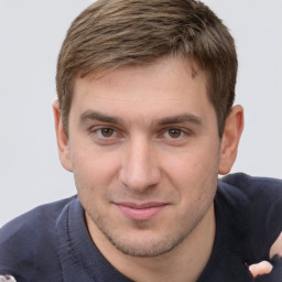 Joyful white young-adult male with short  brown hair and grey eyes