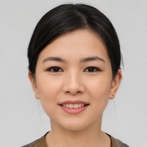 Joyful asian young-adult female with medium  brown hair and brown eyes