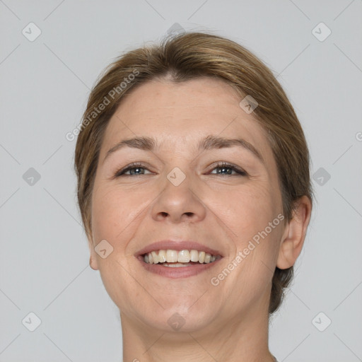 Joyful white adult female with medium  brown hair and brown eyes