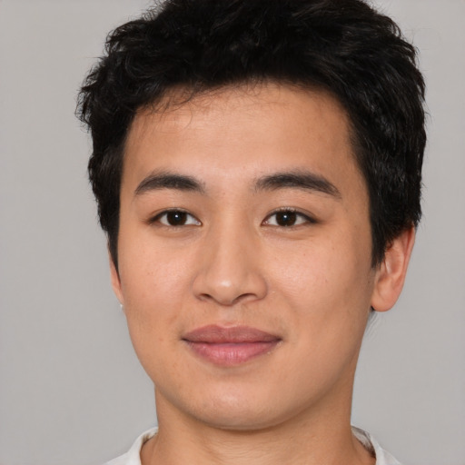 Joyful asian young-adult male with short  brown hair and brown eyes